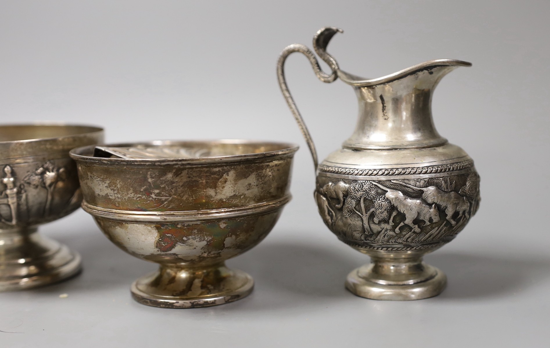 Mixed silver and white metal items including par of toastracks, sugar bowl match sleeve, sauceboat, cream jug, Victorian christening mug, pair of silver mounted clothes brushes, silver mustard silver cigarette case, 25.8